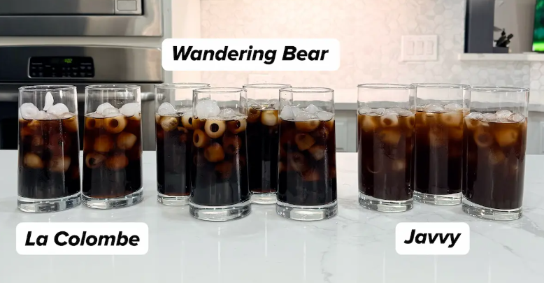 Three sets of cold brew glasses labeled Wandering Bear, La Colombe, and Javvy